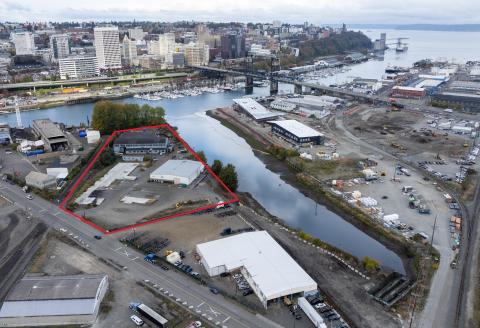 Aerial shot of a cleanup site with the boundary in red next to a waterway.