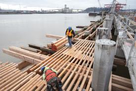 Construction workers building terminal structure. 
